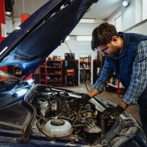 Mechanic repairing exhaust pipe showing how to fix exhaust smell in car