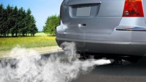 Blue smoke rising from car exhaust due to oil burning inside the engine