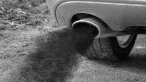 Black smoke coming from car exhaust due to unburned fuel in the engine