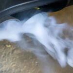 Car releasing white smoke from exhaust when starting car on a cold morning